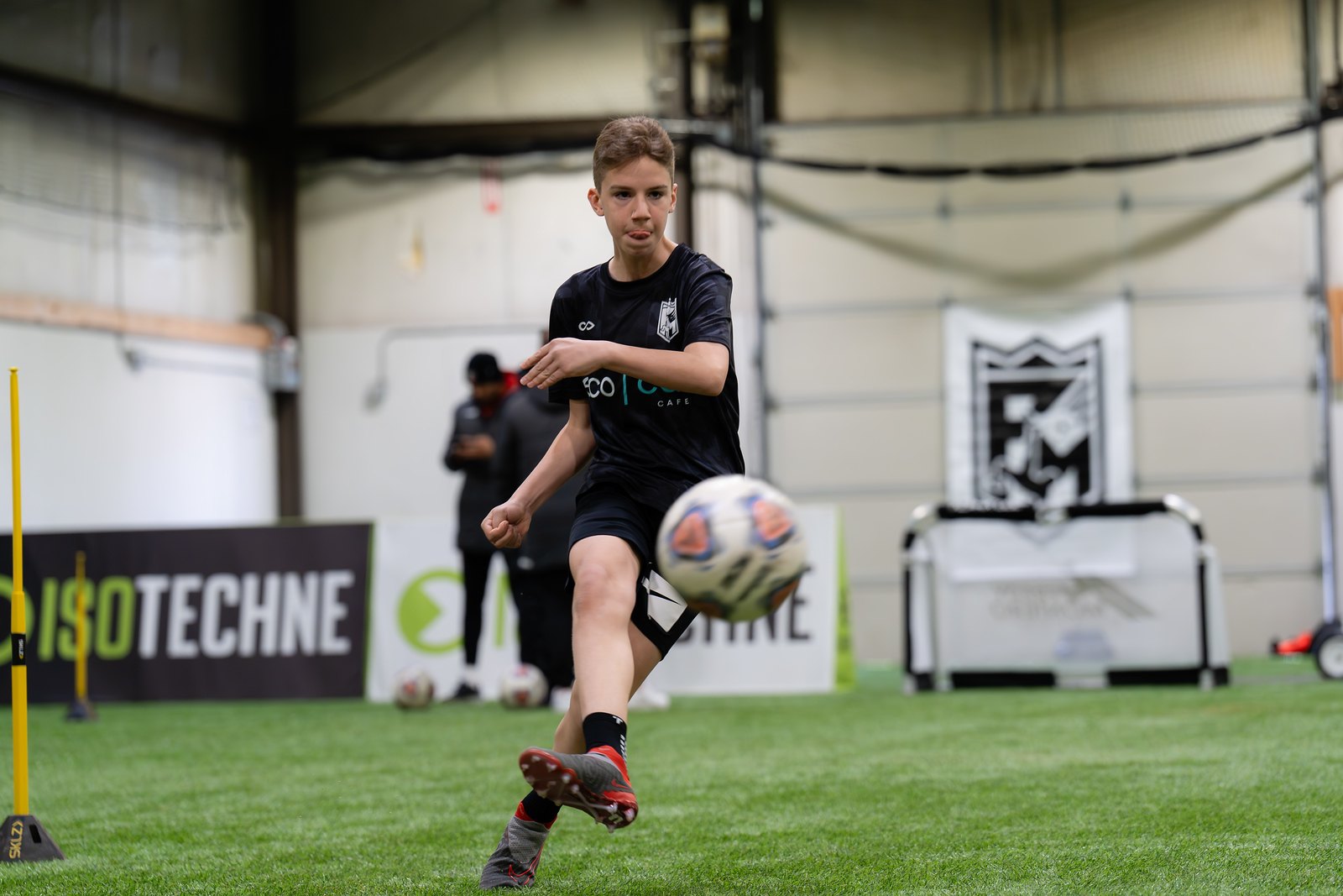 An FM Elite player striking the ball during indoor training